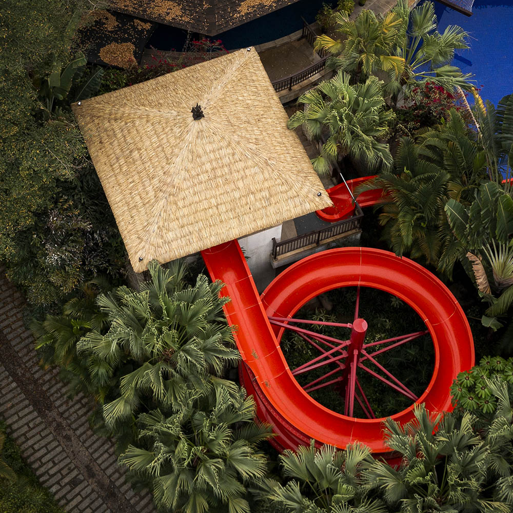 synthetic palm thatched roof on a water park slide tower, aerial view